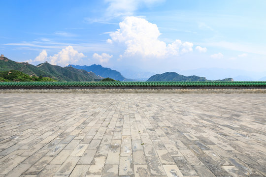 Empty square floor and mountains scene