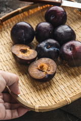Red plums on rustic background