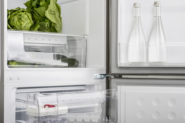 Open fridge full of fresh fruits and vegetables