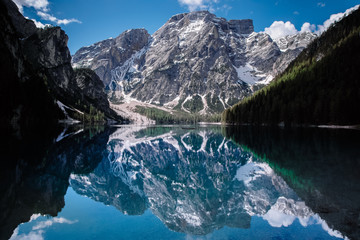 Reflection of the mountain in the water. Amazing view of Braies Lake (Lago di Baraies) in Alps, Italy.