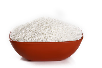 Uncooked rice in a bowl isolated on white background