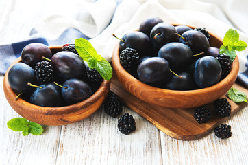 Bowls with fresh plums