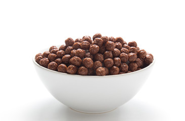 Chocolate cereal balls in a bowl isolated on white background.