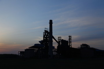 Fototapeta na wymiar Industrial plant equipment in the sunset