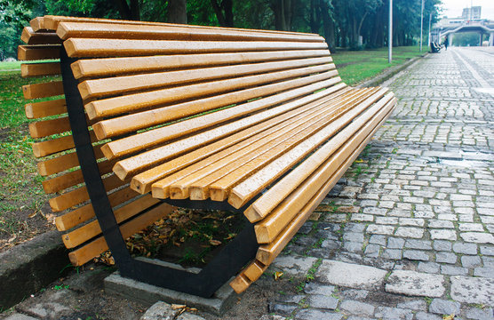 garden bench in the city park after the rain