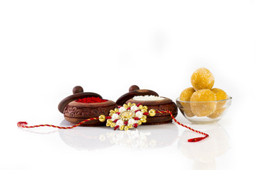 Raksha Bandhan rakhi with flowers diya gift and sweets