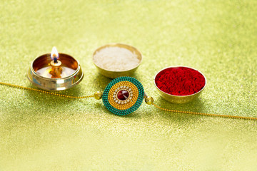 Raksha Bandhan rakhi with flowers diya gift and sweets