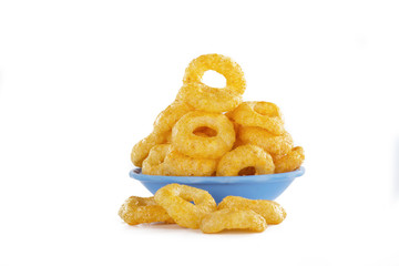 Corn rings snacks in a bowl isolated on a white background