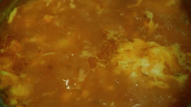 Cooking and adding lovage to the soup when it's boiling.