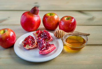 Apple and honey on wood deck, traditional food of jewish New Year - Rosh Hashana.  Selectiv focus.
