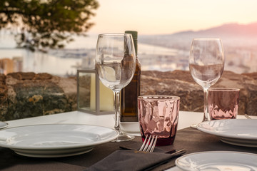 The close-up table in outdoor restaurant with great view over the Malaga city, Costa del sol, Spain