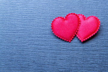 Naklejka na ściany i meble Two red heart on gray surface. Valentine's Day background.