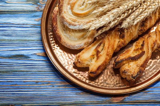 Wheat ears tasty rolls brass tray on vintage wooden board