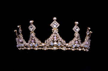 golden crown with pearls and beads isolated on black