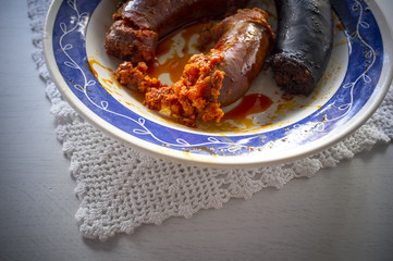 Red chorizo and black sausage morcilla just boiled on a plate over knitting cloth