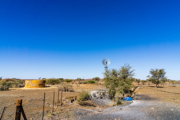 A windmill and water reservoir in Namibia.