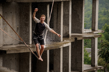 Active young man balancing on a slackline