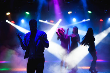 party, holidays, celebration, nightlife and people concept - group of happy friends dancing in night club