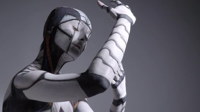 A cyborg woman comes to life, looks around and freezes