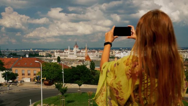 Woman taking travel photos with the smartphone.
