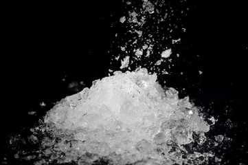 Pile of crushed white ice on black background