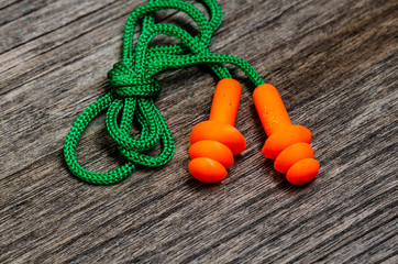 Earplug to reduce noise on a wooden background