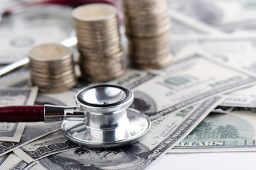 Stethoscope on money background Financial Health Investment Concepts