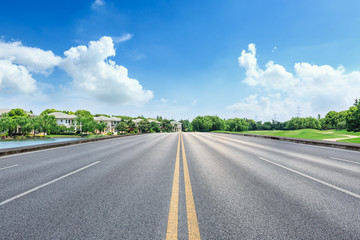 Asphalt road and apartment building scene in the suburbs of the city