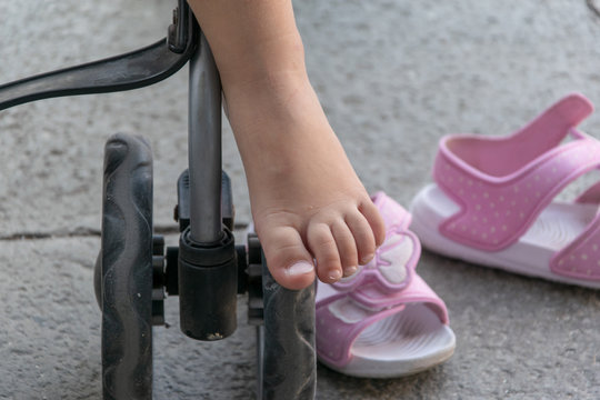 Little girl's foot hanging out the stroller 