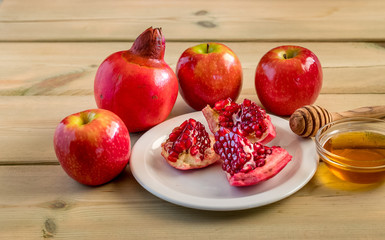 Apple and honey on wood deck, traditional food of jewish New Year - Rosh Hashana.  Selectiv focus.