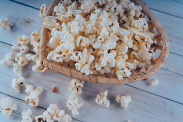 Fresh cooked Salty popcorn on wooden background