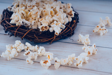 Fresh cooked Salty popcorn on wooden background