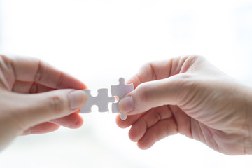 hand holding jigsaw connected to each other on Isolate white background