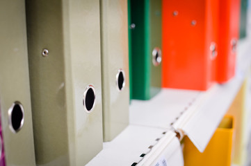 Closeup image of office shelves paperwork dossier binder background. Manage organization...