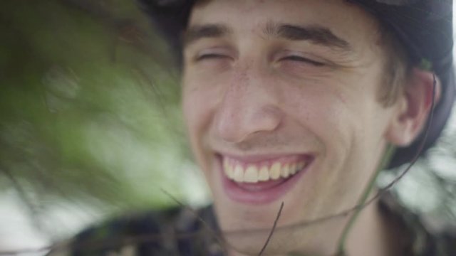 Man in Boonie Wide brim hat smiling into the distance in tropical jungle foliage. Explorer Costume
