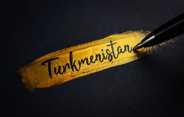 Turkmenistan Handwriting Text on Golden Paint Brush Stroke - obrazy, fototapety, plakaty