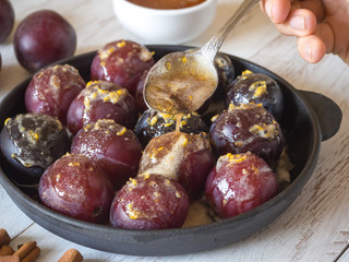 Sweet dessert with plum. Baking plums in sweet sauce.
