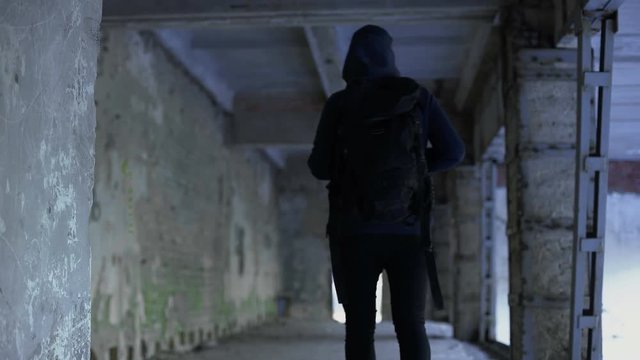 Teenage boy walking in abandoned house, dangerous place, risk of kidnapping