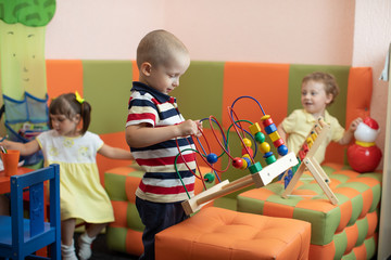 Group of children playing in kindergarten or daycare centre
