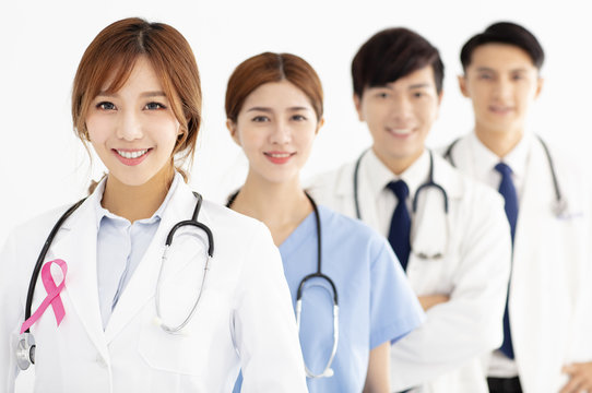 medical team with pink breast cancer awareness ribbon