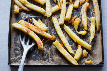 Roasted parsnip with parmesan on baking tray