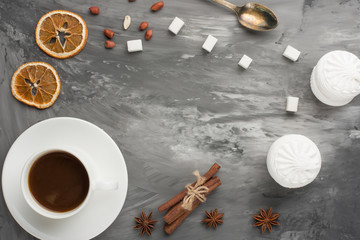Obraz na płótnie Canvas Black coffee on a dark texture with marshmallow, cinnamon