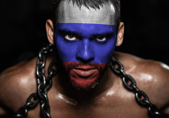Russian flag on the face of a young man