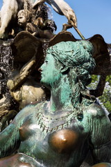 Fototapeta na wymiar Neptune fountain from 1891 by Reinhold Begas with Greek god Poseidon and woman statue with fishnet and grapes represents river Rhine, Berlin, Germany