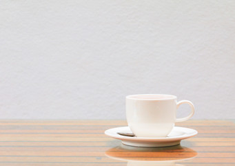 coffee cup white On the glass table wooden and a cement wall background. copy space