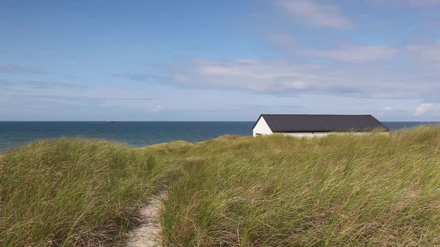 Stenbjerg is a fishing village on the former island of Thy in the northwest of Jutland, Denmark. It is noted for its small white fishermens huts next to the sandy beach.