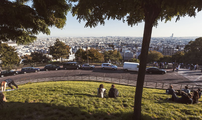 People enjoying city view of Paris from the Sacre Coeur in Montmartre hill