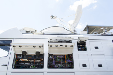 Opened door of parked satellite TV van transmitting breaking news events to satellites for...