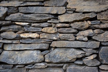 Ancient brick gray coloured raw made of stone wall
