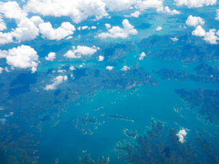 Top view landscape Island mountain and coast with blue sea ocean. View from airplane while flying over Andaman sea in Thailand.